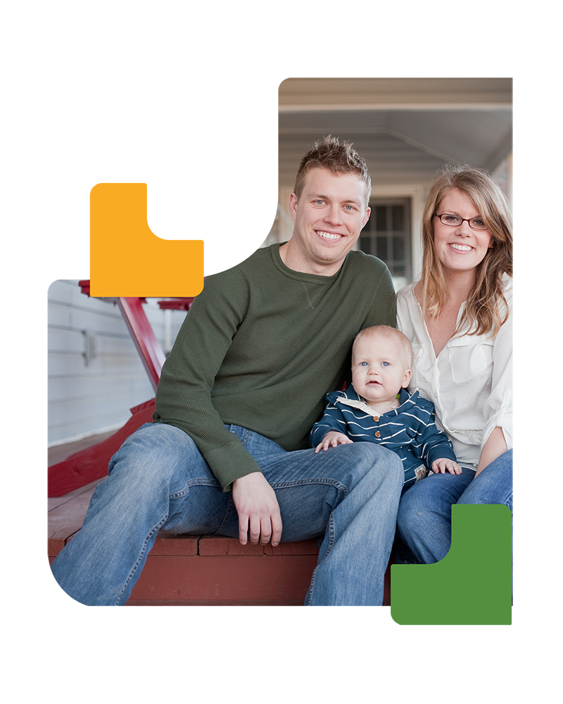 Young couple sitting on porch with their child