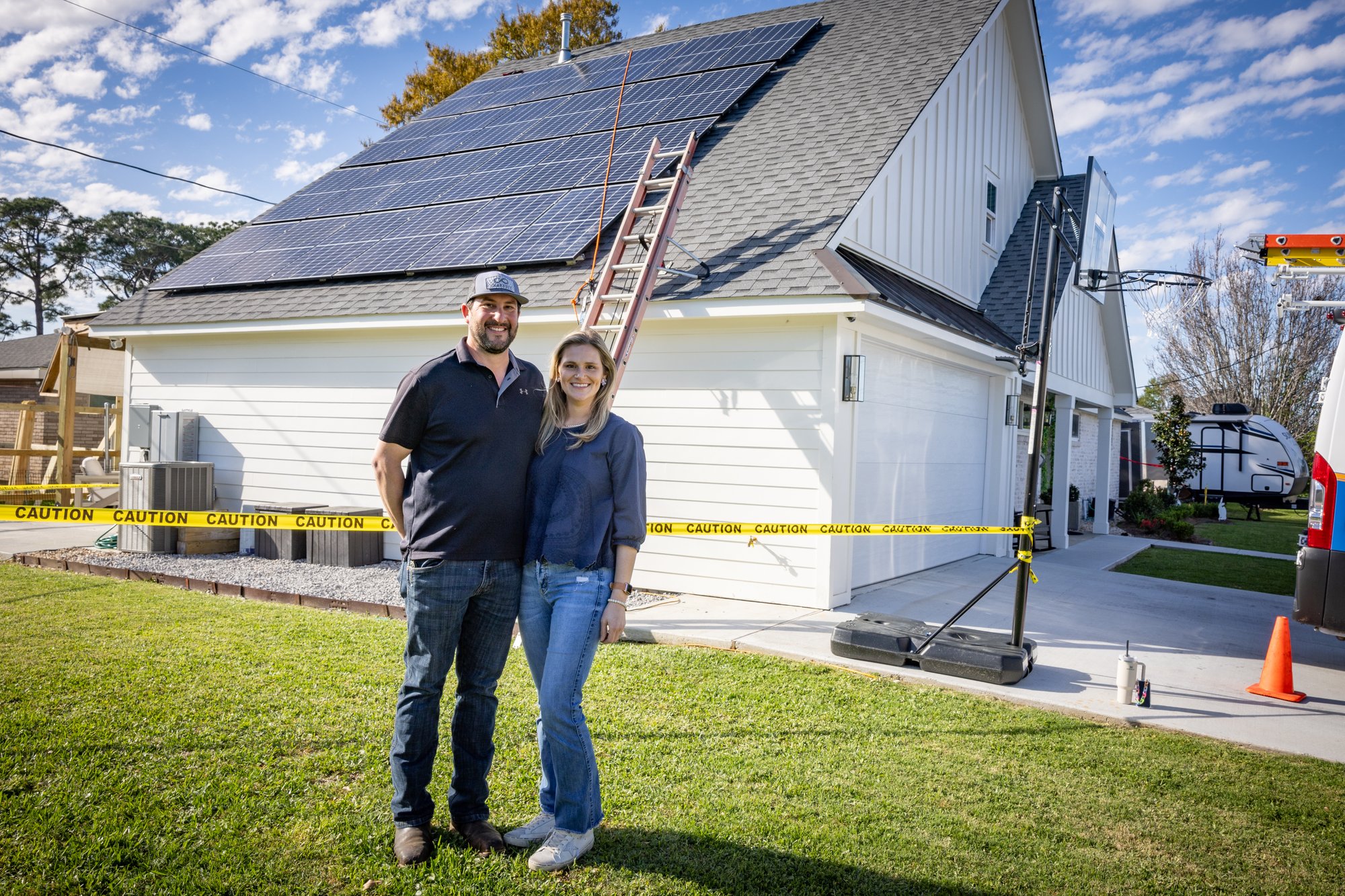 Couple in front of solar panels on house in Metaire LA