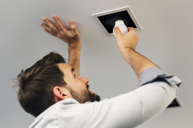 man changing a lightbulb